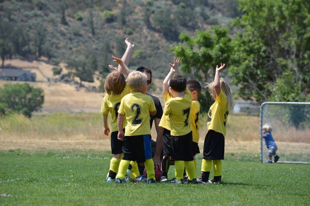 kids playing soccer celebrating